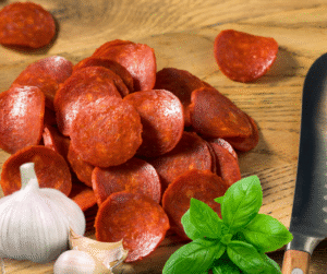 Some paleo pizza soup ingredients - uncured pepperoni, garlic, and fresh basil